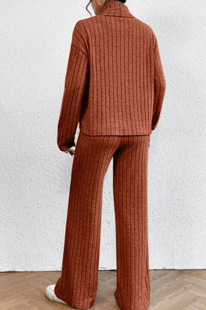 a woman in a brown sweater and pants