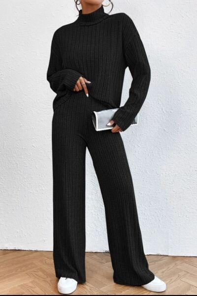a woman wearing a black sweater and pants