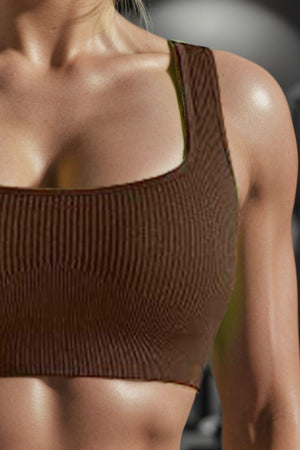 a woman wearing a brown sports bra top