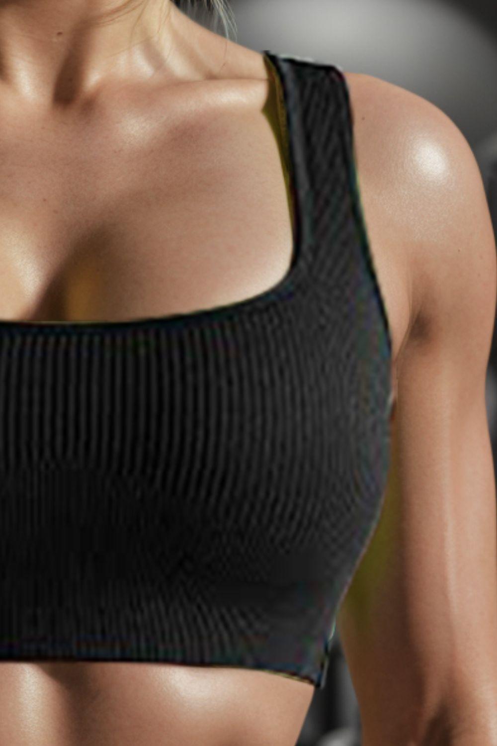 a close up of a woman wearing a sports bra