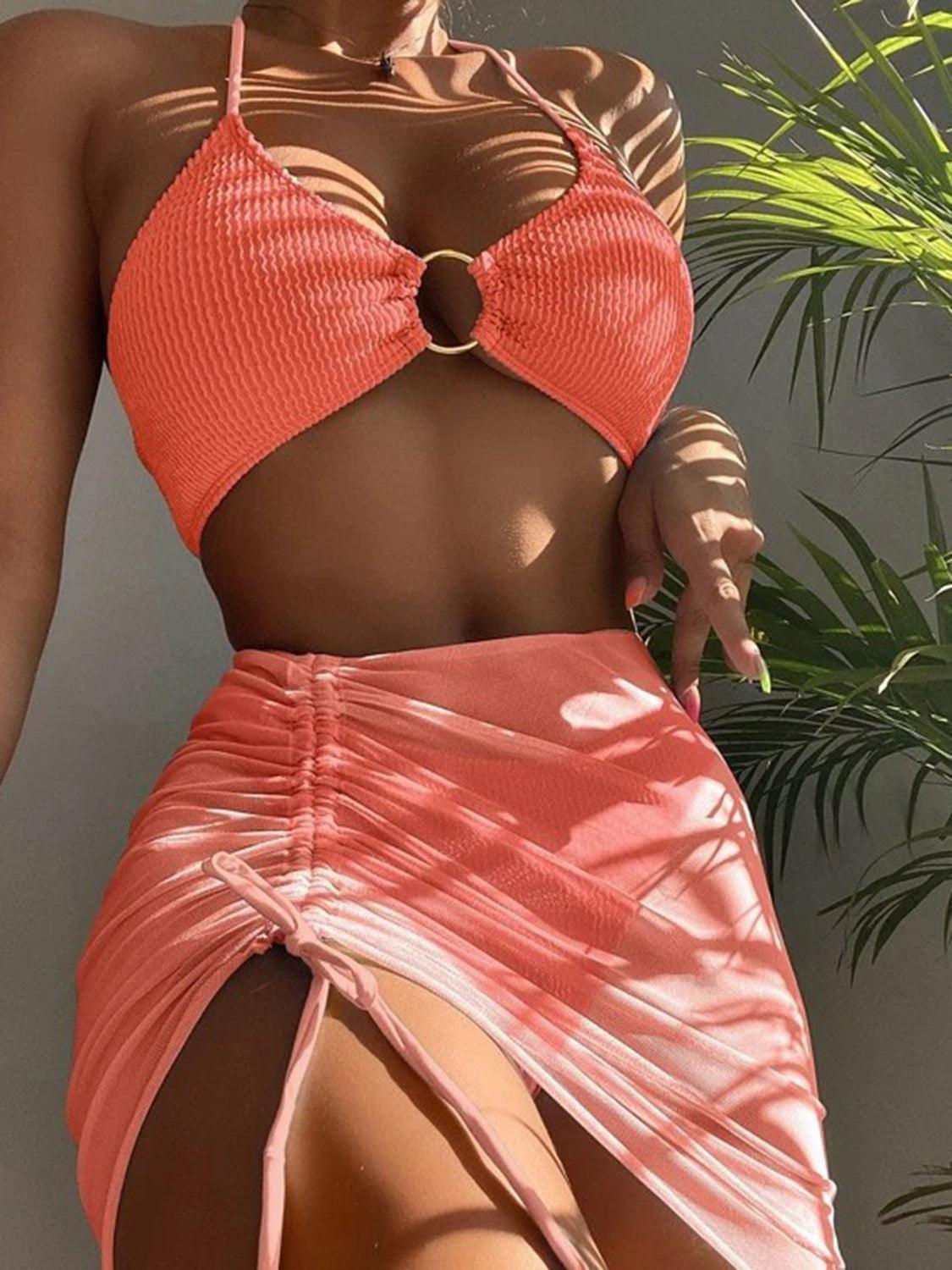 a woman in a bikini top and skirt