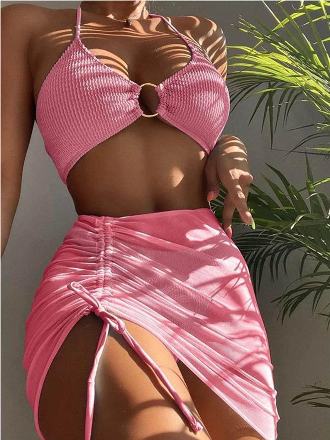 a woman in a pink bikini top and skirt