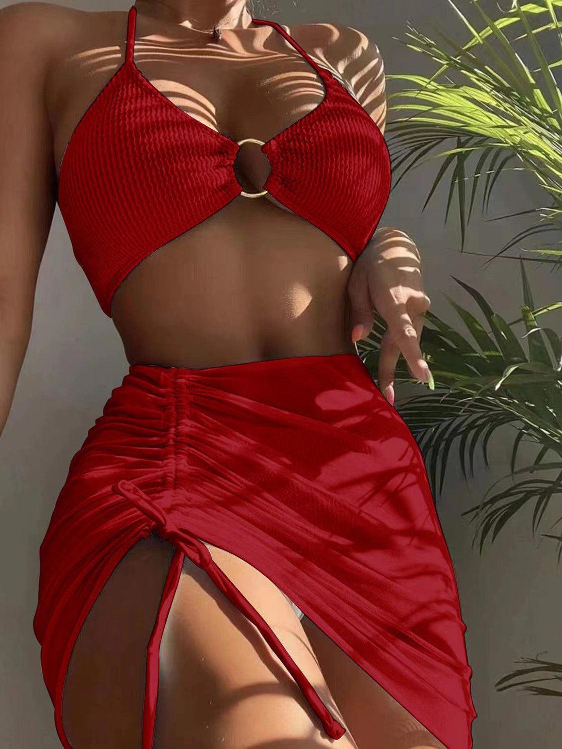 a woman in a red bikini top and skirt