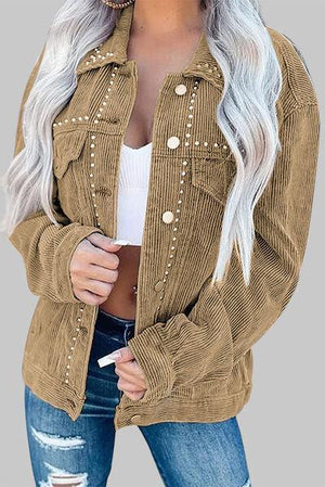 a woman wearing a brown jacket and ripped jeans