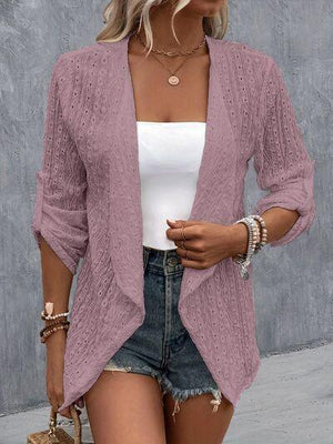 a woman wearing a purple cardigan sweater and denim shorts