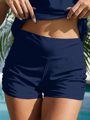 a close up of a person wearing a bikini top and shorts