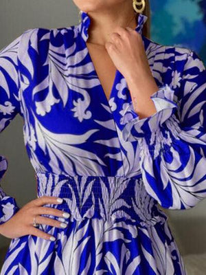 a woman in a blue and white dress posing for a picture