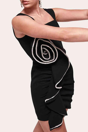 a woman in a black dress is holding a tennis racket