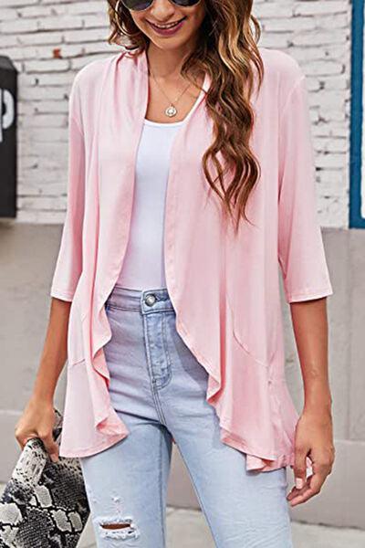 a woman in ripped jeans and a pink jacket