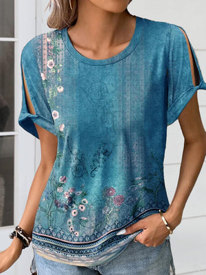 a woman wearing a blue top with flowers on it