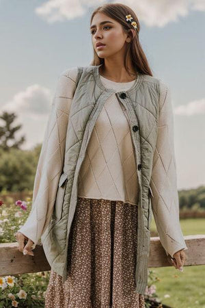 a woman standing next to a wooden fence