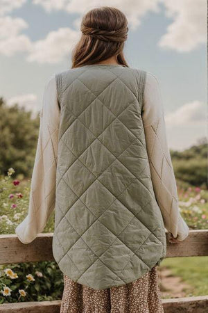 a woman standing on a wooden fence looking at flowers