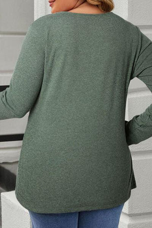 a woman wearing a green sweater and jeans