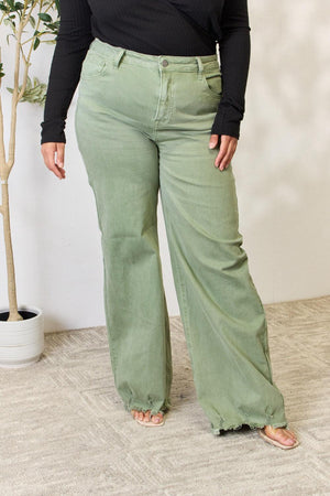 a woman in a black top and green pants