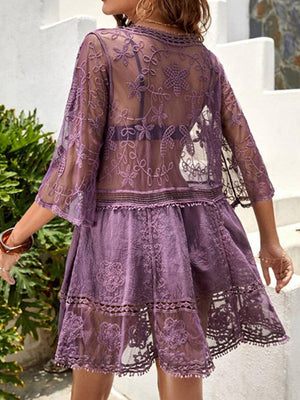 a woman in a purple dress walking down a street
