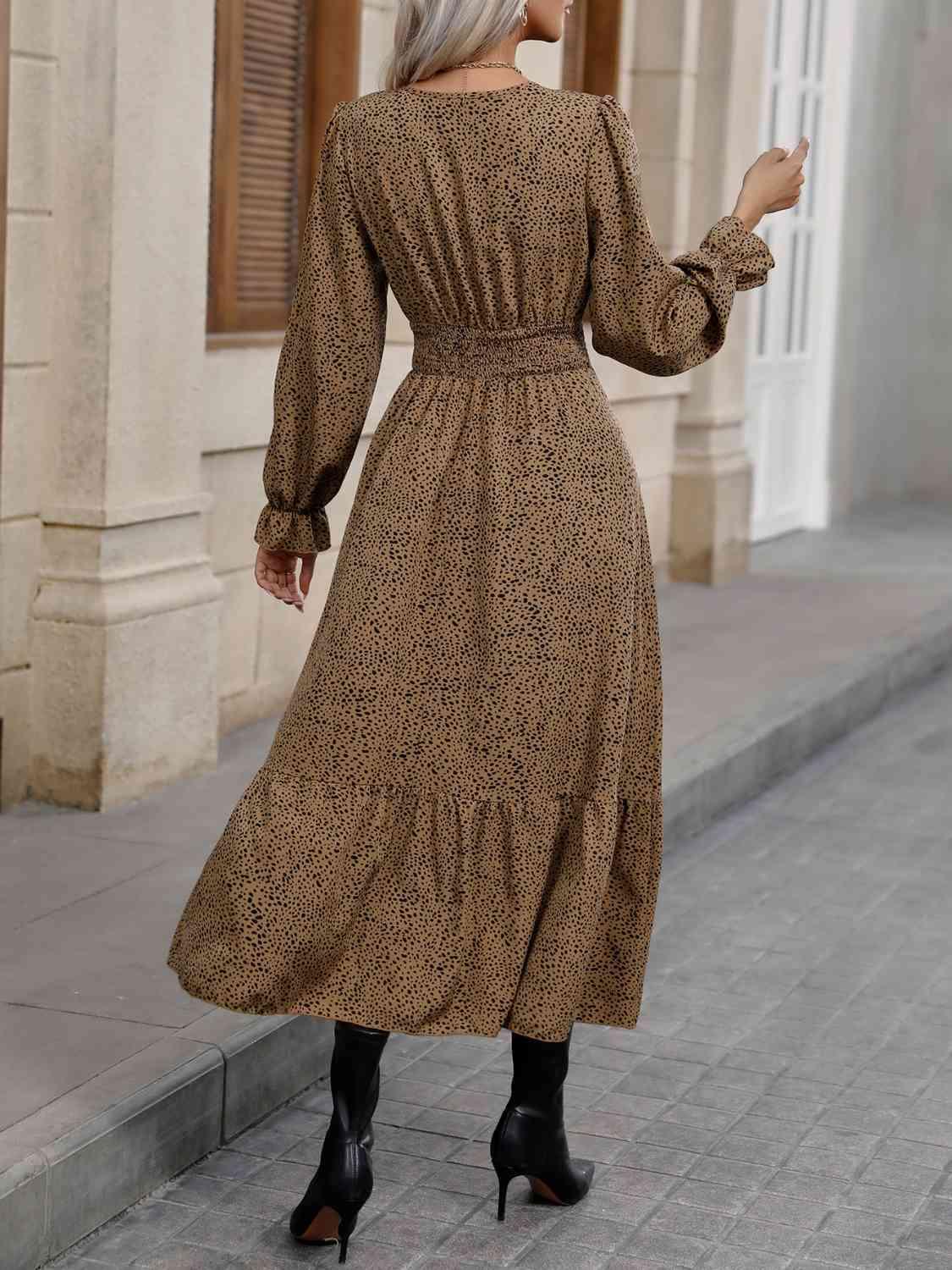a woman in a brown dress is walking down the street