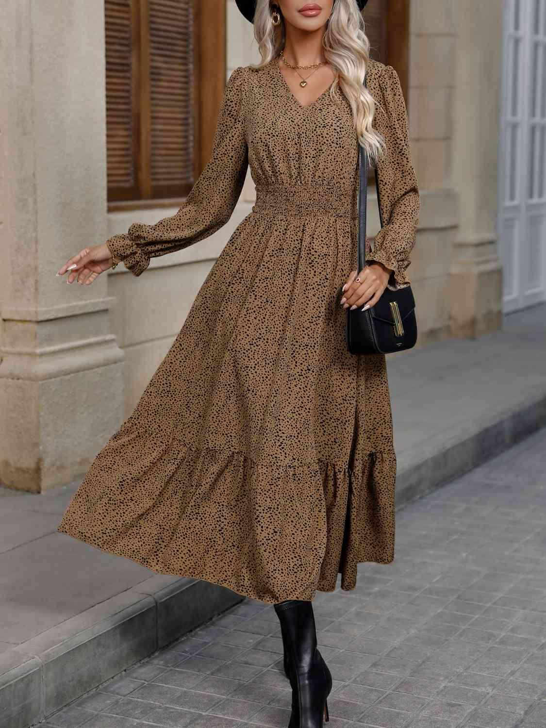 a woman wearing a brown dress and black hat