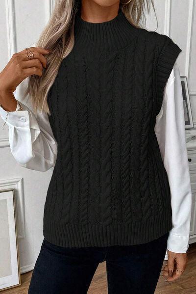 a woman wearing a black and white sweater and jeans