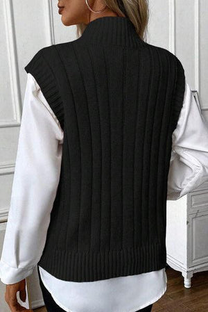 a woman wearing a black and white sweater vest