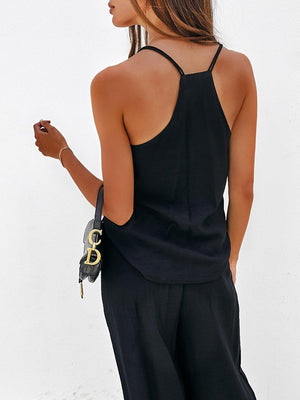 a woman wearing a black top and black pants