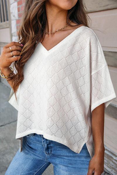a woman wearing a white sweater and jeans