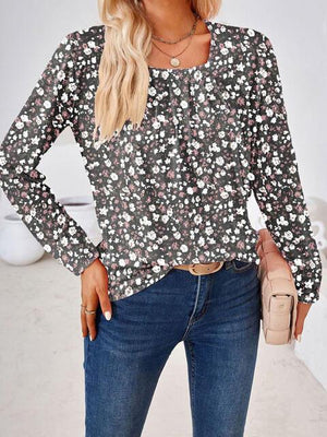 a woman wearing a black and white floral top