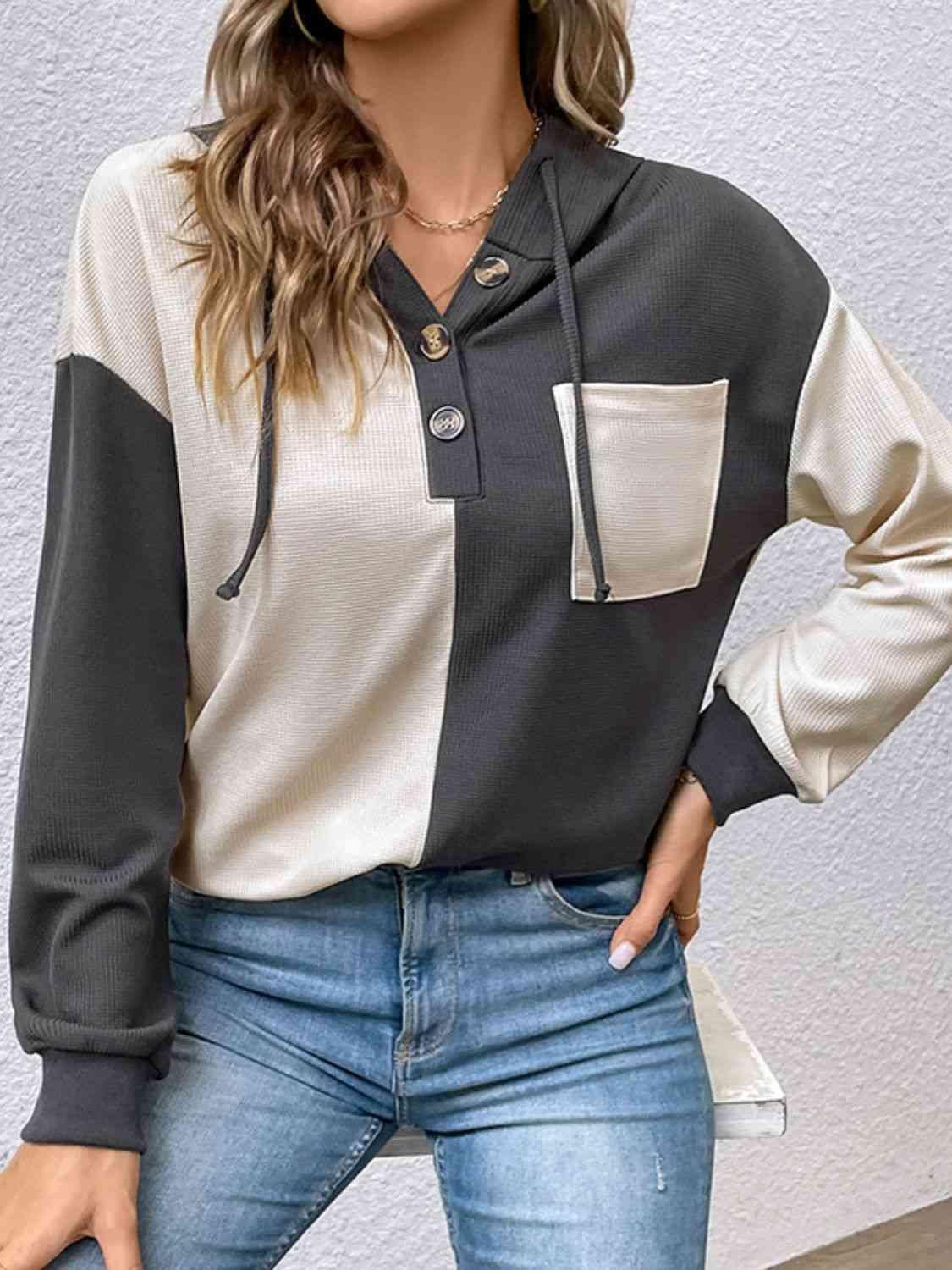 a woman wearing a black and white shirt and jeans