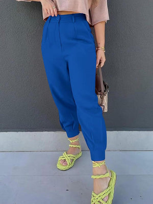 a woman in a pink top and blue pants