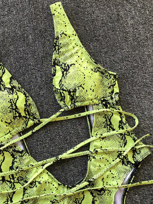 a close up of a yellow snake skin bra