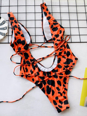 a woman's bikini top with an animal print