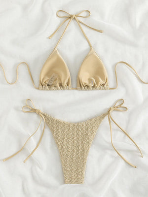 a bikini top and panties on a bed