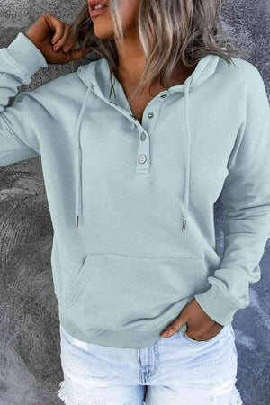 a woman wearing a light blue hoodie