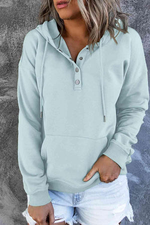 a woman wearing a light blue hoodie