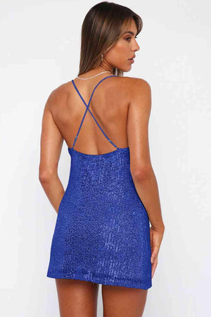the back of a woman wearing a blue dress