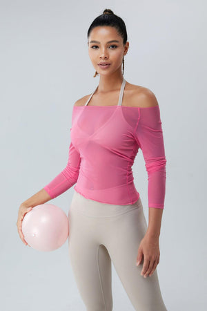 a woman in a pink top holding a pink ball