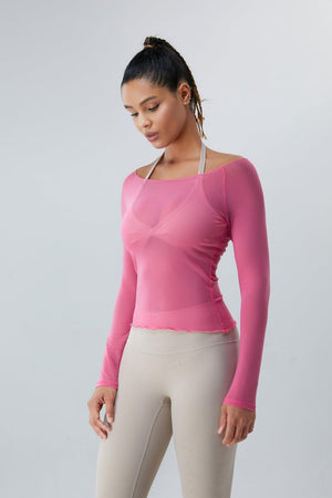a woman wearing a pink top and beige pants