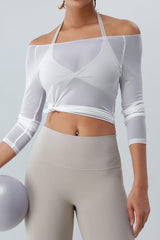 a woman in a white crop top holding a ball