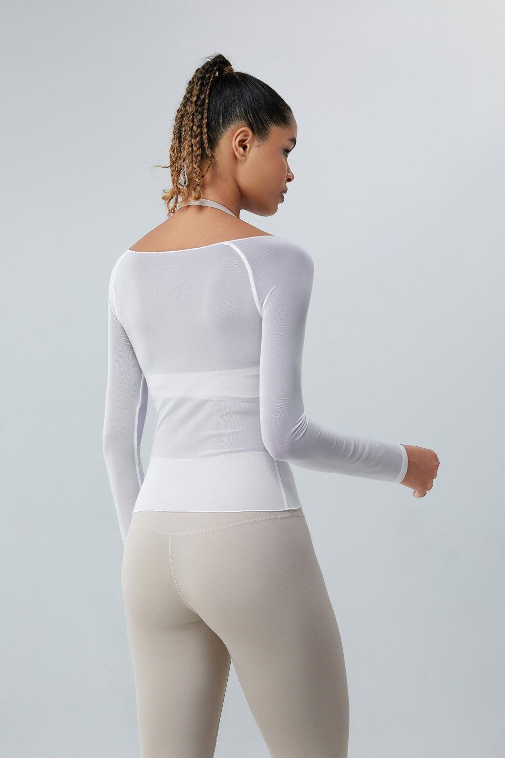 a woman in a white top and leggings
