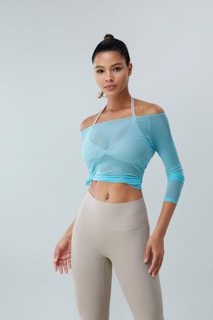 a woman in a cropped top and leggings