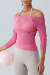 a woman in a pink top holding a pink balloon