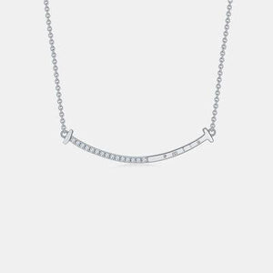 a silver necklace with a bar on it