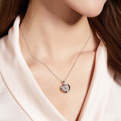 a woman wearing a necklace with a heart on it