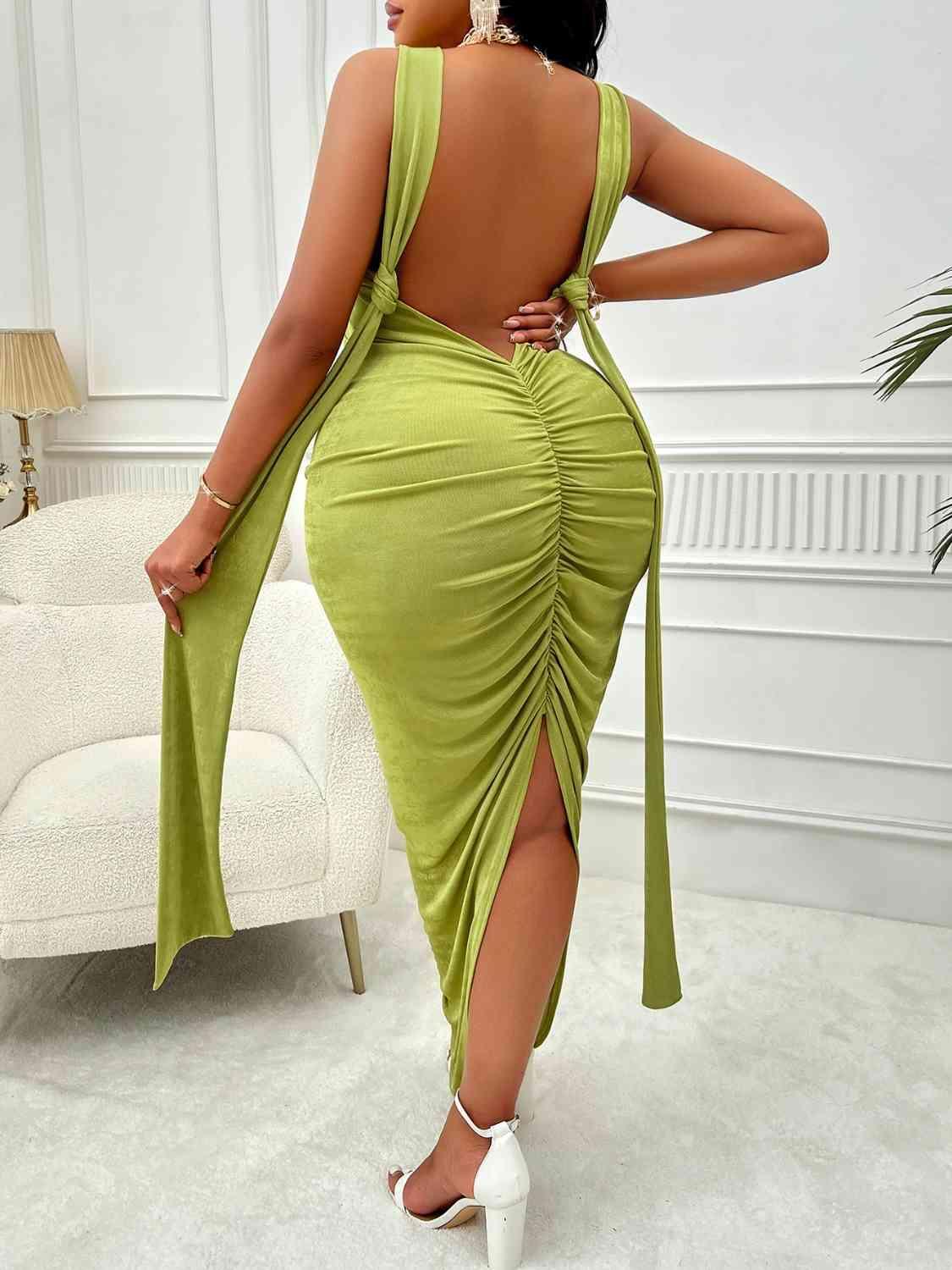 a woman in a green dress with a backless dress