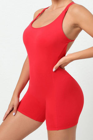 a woman in a red bodysuit posing for a picture