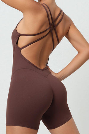 a woman wearing a brown bodysuit with a cross back