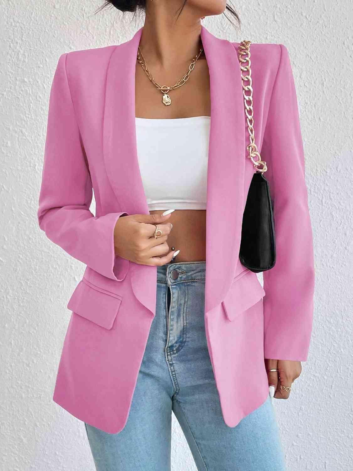 a woman wearing a pink blazer and jeans