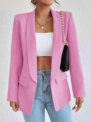 a woman wearing a pink blazer and jeans