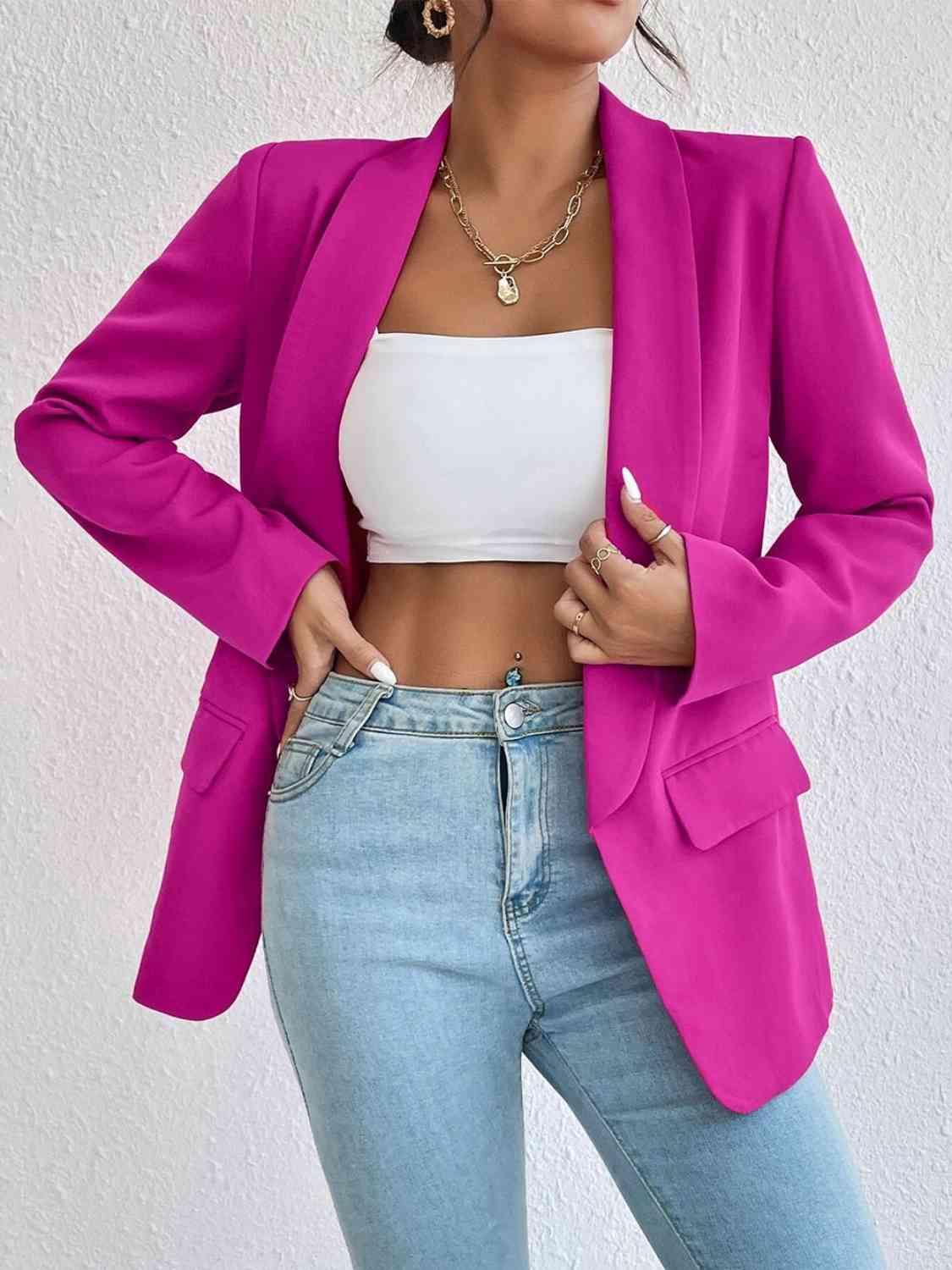 a woman wearing a pink blazer and jeans