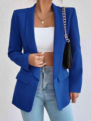 a woman wearing a blue blazer and jeans