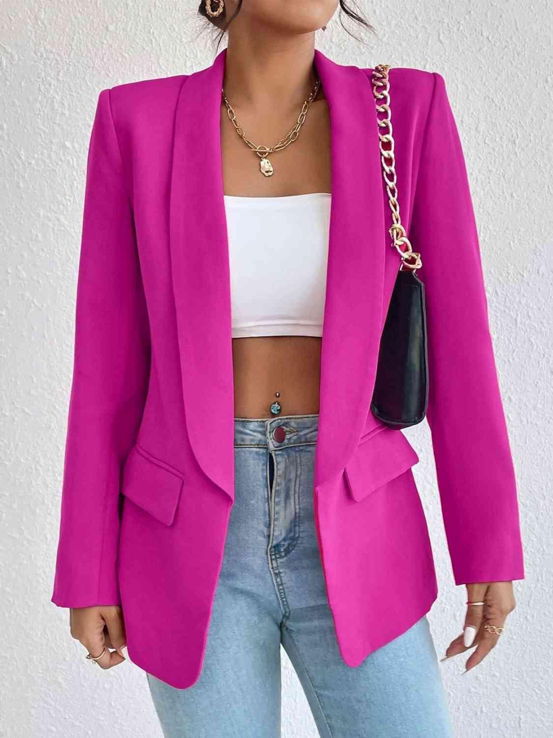 a woman wearing a pink blazer and jeans